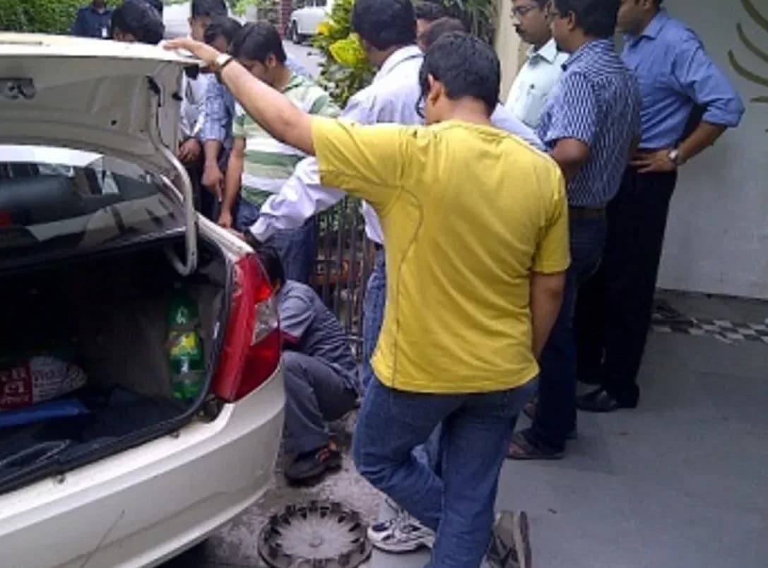 A group watching a tyre change demonstration