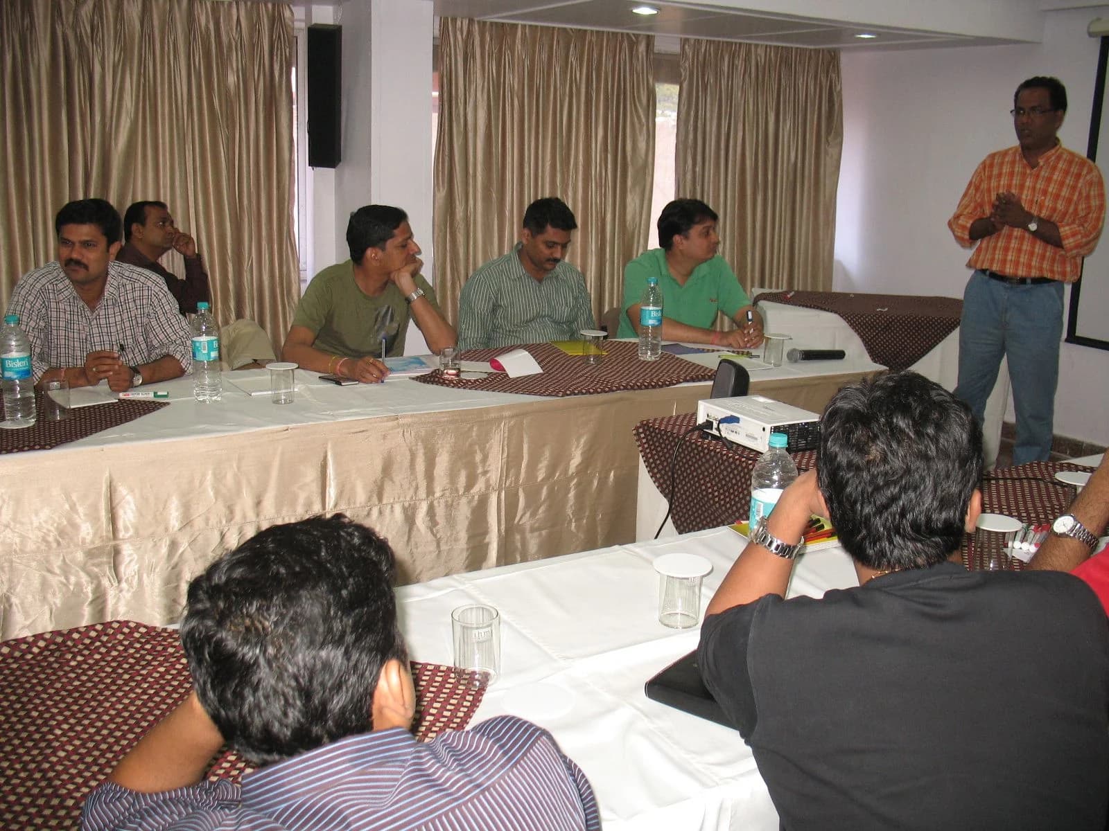 A facilitator presenting to a seated group